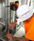 Worker using a Cordless Rechargeable Fan With USB-C Charging Cord And Multiple Mounting Options For The Jobsite, Magnetic Base visible.