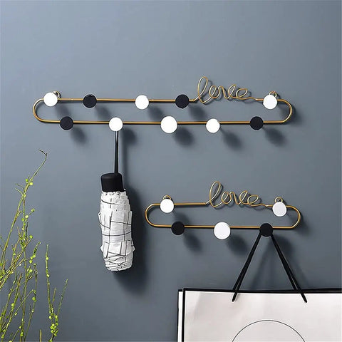 Top Shelf Gold Wrought Iron Letter Wall Hooks for keys coats and hats, featuring a stylish love design with hooks.