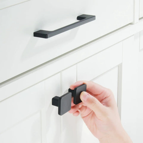 Rock Solid Matte Black Cabinet Handles And Drawer Pulls Bringing A Clean Five Inch Screw Layout, showcasing a hand gripping a square pull.