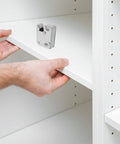 Man installing Stainless Steel Door Roller Catch 2 Pack Press To Open Cabinet Latch With Nylon Wheel on white cabinet shelf