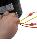 Person holding wires of HVAC Blower Motor Three Quarter HP One Phase Three Speed 208 And 230 Volt 1075 RPM with capacitor