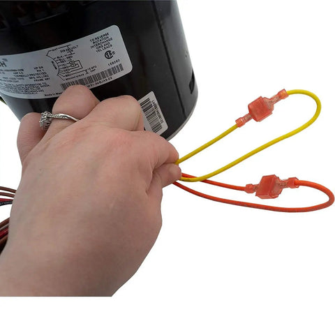 Person holding wires of HVAC Blower Motor Three Quarter HP One Phase Three Speed 208 And 230 Volt 1075 RPM with capacitor