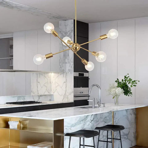 Modern Sputnik Chandelier With 6 Lights In Brushed Brass above kitchen counter with marble finish