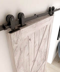 5.5 Foot Bypass Barn Door Hardware Kit For 33 Inch Double Doors installed on wooden sliding door showing steel construction and nylon rollers