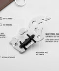 Compact Metal Multitool Card With Screwdriver And Bottle Opener For Wallet Or Bag shown with hex wrenches and keychain attachment.