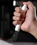 Dope Pink Magnetic Telescopic Coffee Distribution Needle And Rock Solid Stainless Steel Espresso Grounds Leveler in hand.