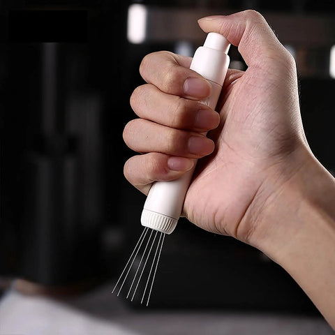 Dope Pink Magnetic Telescopic Coffee Distribution Needle And Rock Solid Stainless Steel Espresso Grounds Leveler in hand.