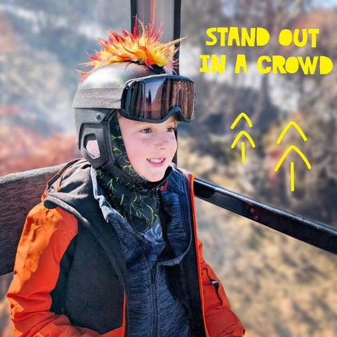 Child wearing iguana themed helmet mohawk accessory with sticky hook and loop fastener adhesive, skiing gear, outdoors