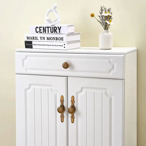 White cabinet with Antique Brass Round Cabinet Knobs And Drawer Pulls Set, 10 Pack, 1.4 Inch, Zinc Alloy Hardware, floral motif.