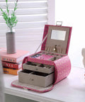 Eight Point Eight Inch Hot Pink Travel Jewelry Organizer Case With Built In Mirror And Snug Pockets on a dresser with jewelry inside.