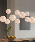 Top Shelf Modern Crackle Glass Sphere Pendant Cluster Integrated Led Brass Finish Adjustable Cord Lighting For Duplex Staircases Heavy Duty Mounting Is Big Time Game Changer over dining table with decorative plants.