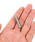 Hand holding metal nib from the 55Pcs Wood Burning Tool Set With Metal Engraving Nibs And Replacement Tips For Pyrography And Woodcrafts Jewelry Engraver And Carving Bits Kit For DIY Woodworking Projects
