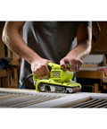 3 By 18 Inch Compact Belt Sander Sporting A Gutsy 6 Amp Motor Built Like A Tank To Crush Heavy Duty Woodworking in use on a workbench.