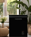 Hella Spacious 7.0 Cu.Ft Chest Freezer In Bold Black showing easy-adjust thermostat in a stylish living space.