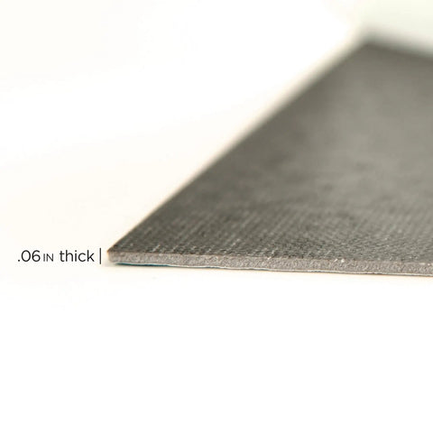 Close-up of edge showing thickness of Grey Peel And Stick Floor Tiles Pack Of 10 Geometric Vinyl Flooring Water Resistant 12 In By 12 In Easy Diy Install No Grout Needed Durable Adhesive Low Lustre Finish.