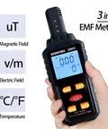 Three In One EMF Meter And Reader For Home Office And Outdoors Electromagnetic Field Radiation Detector held by a hand
