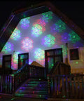 Motion Pattern Firefly 3 In 1 RGB Outdoor Laser Christmas Lights Projector With 18 Moving Patterns illuminating a house facade