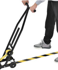 Heavy Duty Floor Tape Applicator For Zero Sweat Safety Line Layout With Dual Comfort Grip Handles and Rock Solid Steel Frame in use laying tape.