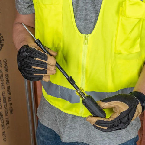 Worker holding a One Handed Phillips Screw Holding Screwdriver With 7 Inch Round Shank Cushion Grip Handle For Superior Torque
