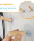 6 Piece Extra Long Wooden Wall Hooks Self Adhesive Coat Rack For Doors Easy Peel Stick mounted on wall with hands holding a hook.