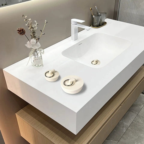 Heavy Duty Rubber Drain Stopper With Sturdy Pull Ring, Six Piece Set Of White Sink Plugs on modern sink countertop.