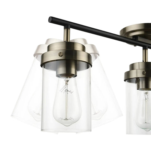 Close-up of Vintage Vibe Three-Light Track Lighting Bar With Pivoting Heads in Matte Black and Antique Brass Finish, clear glass shades.