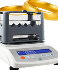 Heavy Duty Digital Gold Purity Tester Machine Featuring Dead Accurate Density Calibration And Rugged 0.001 Gram Precision Scale For Real Jewelers And Lab Pros Includes Compact Printer with displayed gold rings.