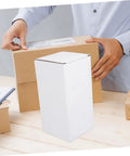 Person handling White Corrugated Small Mailer Boxes Pack 10 Lightweight Shipping Boxes For Packaging And Mailing
