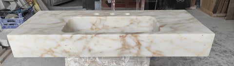 Top Shelf Hand Carved Afyon Honey Marble Bathroom Vanity Sink With Slick Countertop Setup And Durable Natural Stone Craft For Upscale Residential Or Swanky Commercial Decor. View of smooth top surface with faucet holes.