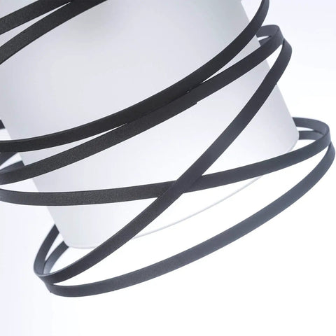 Close-up of Sleek Modern Mini Pendant Light with matte black spiral cage encasing handblown frosted glass shade for kitchen island and dining room