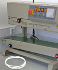 Four Pack Heavy Duty Rubber Replacement Belts For Sealing Machines featuring precise tooth design on an industrial sealing machine.