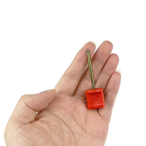 Red pin from Archery Target Pins 15 Pack Durable Plastic And Manganese Steel Pins For Holding Paper Targets On Foam, 6.6 cm length shown in hand