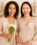 Two women at a boho themed party wearing 40 Count Pink and Blue Hot Air Balloon Gender Reveal Stickers for Team He and Team She.