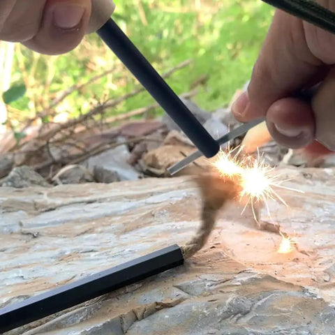 Close-up of Flint And Steel Fire Starter Kit With Ferro Rods And Magnesium creating sparks, outdoors, suitable for camping hacks.