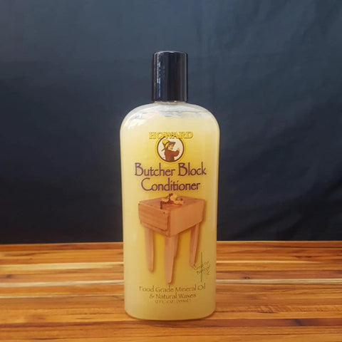 Butcher Block Conditioner With Food Grade Mineral Oil For Wood Cutting Boards And Spoons 12 Fl Oz bottle on wood surface