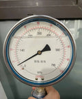 Front view of WIN-WIN waterjet high-pressure gauge showing MPa scale and 1000 psi label, held by hand