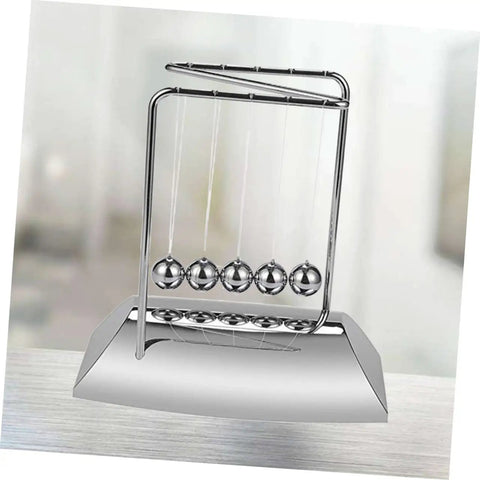 Z Shape Newton Cradle Pendulum Desk Toy For Home Office Decor on modern desk, silver finish, demonstrating energy dynamics.