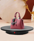 Smooth Electric Rotating Display Stand 360 Degree Turntable with Pure Copper Motor showcasing a pink handbag on a sleek black base.