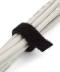 Black fire retardant reusable cable tie securing white cables, half inch wide, 16 feet long, shown in close-up for organization.