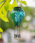Lit Hot Air Balloon Solar Lantern With Flickering Flame Light, Tie Dye Glass Outdoor Lamp hanging on tree branch