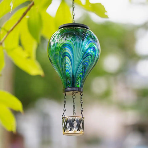 Lit Hot Air Balloon Solar Lantern With Flickering Flame Light, Tie Dye Glass Outdoor Lamp hanging on tree branch