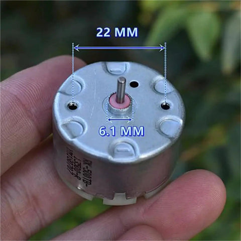 Close-up of Mini 32mm Round Spindle Motor, DC 6V 9V 12V, 5600 RPM with 22mm width and 6.1mm shaft diameter in hand.