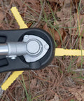Trimmer head with yellow Push N Load Nylon Replacement Blades for Three Blade Trimmer Heads on grass and leaves