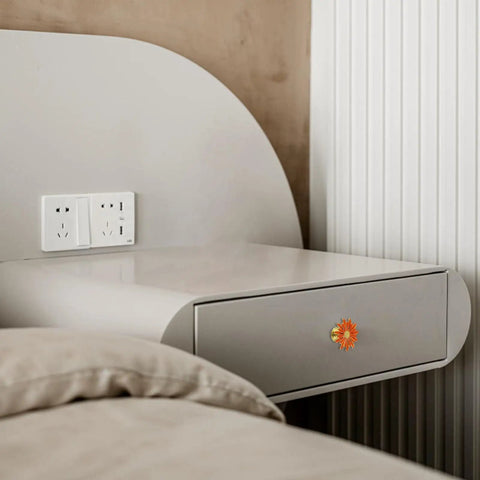 Side view of bedside table with Five Pack Flower Drawer Knobs In Orange Zinc Alloy Cabinet Dresser Pulls, installed on drawer.