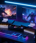 Dual Monitor Stand Riser With Drawer And Pen Holders Desk Organizer And Book Racks For Office Desk Accessories Boss Level Workspace Organizer For Two Monitors In Black, with two monitors on top and illuminated accessories.