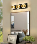 Modern Up And Down LED Vanity Light 36W With Built In LEDs In Black Gold Finish above a bathroom mirror