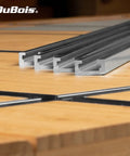 Heavy Duty Universal Aluminum T Track Four Pack With Smooth Double Cut Channels and Predrilled Mounting Holes on wood surface.