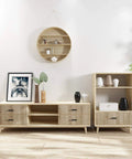 Modern living room with wooden media console, black handles, decorative vases, framed art, and open shelving against white wall.