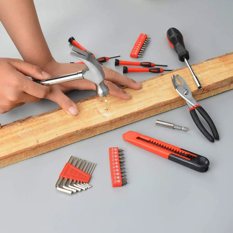 Using 39 Piece Home Tools Kit With Plastic Toolbox Handy Starter Set for DIY projects, featuring hammer, pliers, and screwdriver bits.