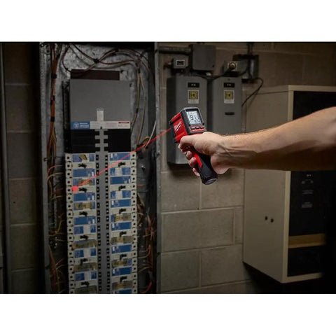 Person using 10 To 1 Infrared Temperature Gun With Easy One Hand Operation Durable Construction Quick Temperature Readings For HVAC Plumbing And Electrical Work Handheld Red Tool For Accurate Surface And Appliance Temps on electrical panel.